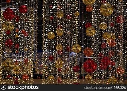 Colorful christmas Decoration. Winter holidays and traditional ornaments on a Christmas tree. Lighting chains - candles for seasonal background.