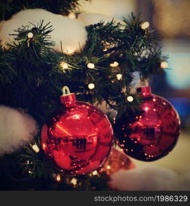 Colorful christmas Decoration. Winter holidays and traditional ornaments on a Christmas tree. Lighting chains - candles for seasonal background.