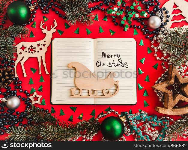 Colorful Christmas decorations, silver beads, branches of the Christmas tree, multicolored tinsel on a red surface. Top view, close-up, flat lay. Greeting card. Colorful Christmas decorations and silver beads. Greeting card