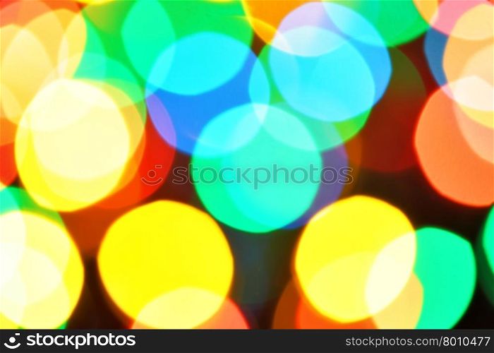 Colorful christmas lights out of focus and stars, may be used as background