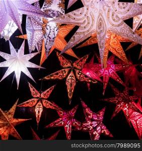 Colorful Christmas stars. A background of star lanterns.