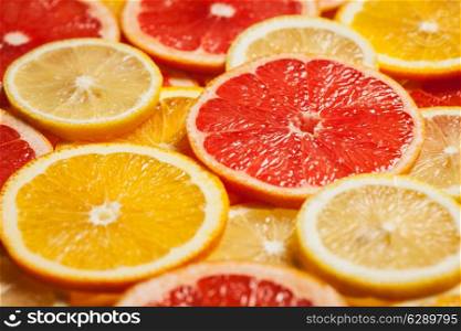 Colorful citrus fruit - lemon, orange, grapefruit - slices background