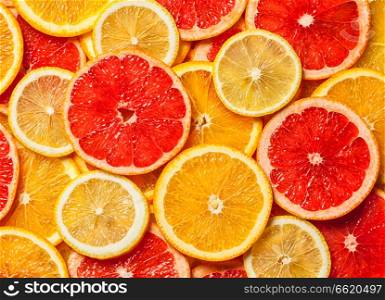Colorful citrus fruit - lemon, orange, grapefruit - slices background. Colorful citrus fruit slices