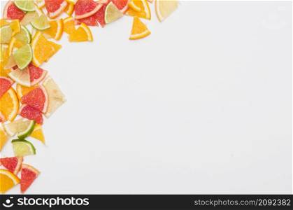 colorful citrus fruit slices corner white background