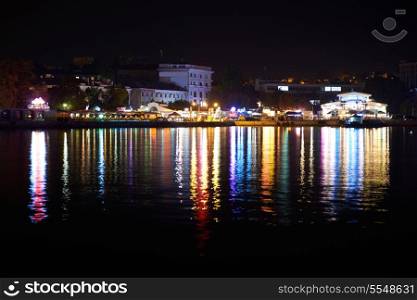 Colorful city illumination at night. View from the seafront
