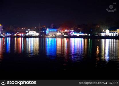 Colorful city lights with soft water reflection