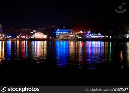 Colorful city lights with soft water reflection