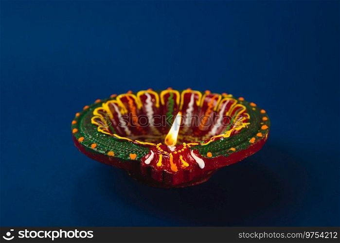 Colorful clay diya l&s shine bright, happiness and prosperity. Perfect for Diwali Holi and religion-themed invitations. Shiny, glowing l&s festive ambiance. Diwali and Holi celebration.