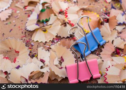 Colorful clips placed on a pencil shavings