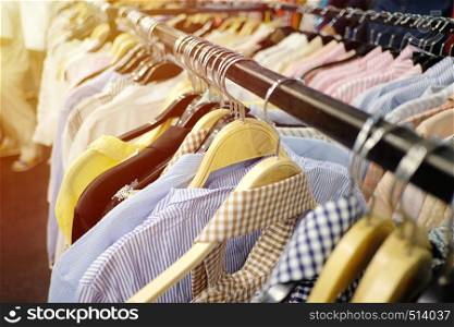 Colorful clothes hanging on clothesline and have orange sunlight shines in the daytime for design in your work.