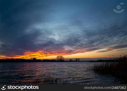 Colorful clouds after sunset on the lake, Stankow, Lubelskie, Poland