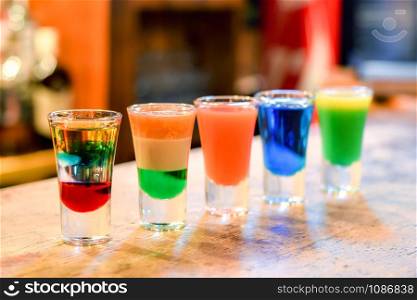 Colorful cocktails on a bar stand.