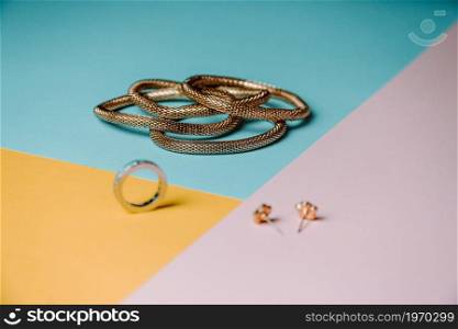 Colorful concept shot of jewelry with rings and earrings with three colors and minimal style