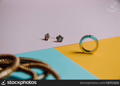 Colorful concept shot of jewelry with rings and earrings with three colors and minimal style