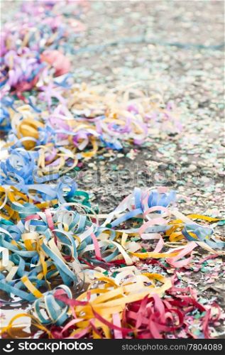 colorful confetti and streamers at the street after Carnival Parade (shallow DOF)