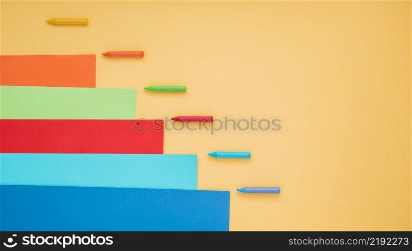 colorful crayon craft paper arranged yellow surface