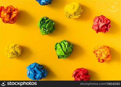 colorful crumpled paper ball yellow background. High resolution photo. colorful crumpled paper ball yellow background. High quality photo