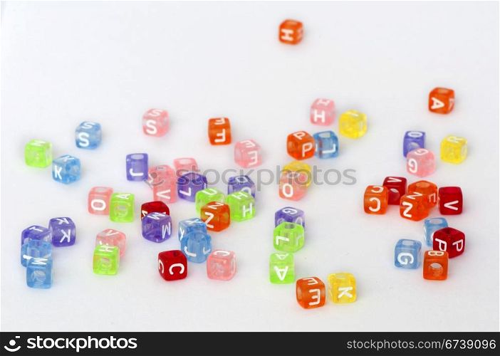 Colorful cubes with letters scattered randomly over white