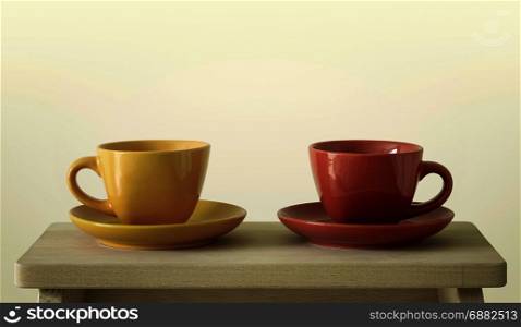 colorful cups on wooden table