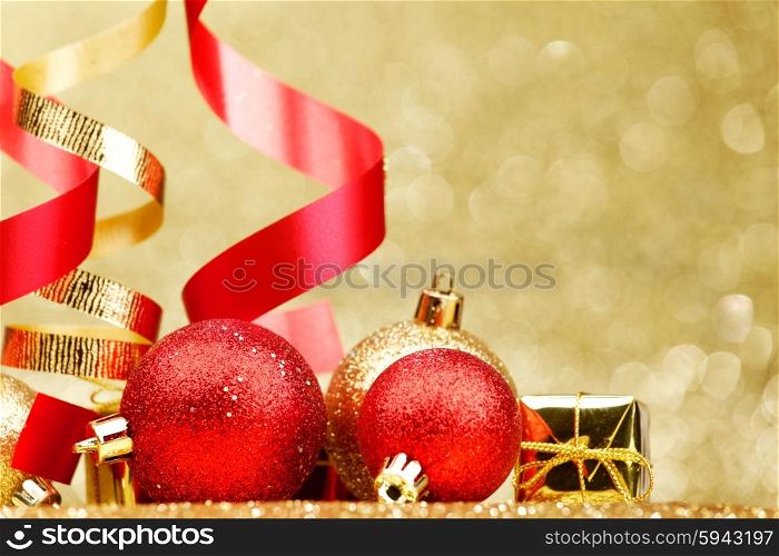 Colorful decorative curling ribbons and balls over glitter background