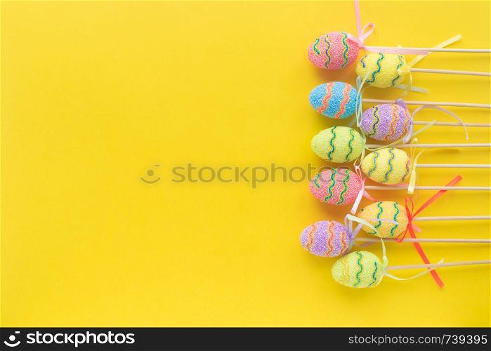 Colorful decorative Eggs on yellow background .Christian religious holiday. Happy Easter. Free spase. Top view. Flatlay. Colorful decorative Eggs on yellow background .Christian religious holiday. Happy Easter. Free spase. Top view