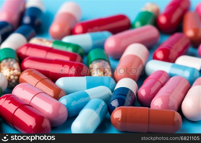 Colorful different medicine capsules. Colorful different medicine capsules on blue background