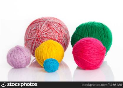 colorful different thread balls. wool knitting on white background