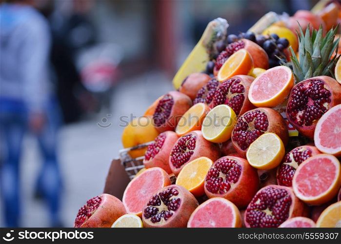 Colorful display of fruits background on traditional local market ready to made fresh juice drink