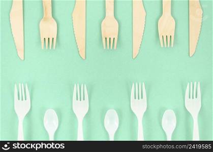 colorful disposable cutlery turquoise background