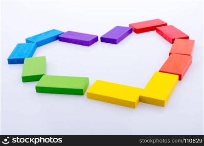 Colorful Domino Blocks forming a Heart on a white background