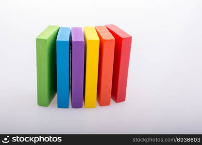 Colorful Domino Blocks in a line on a white background