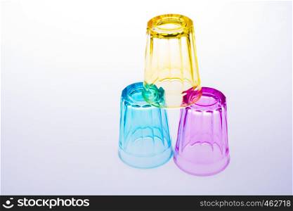 Colorful drinking glass lined up on white background