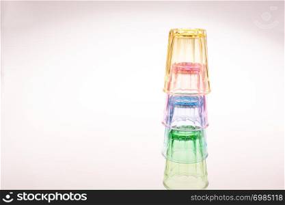 Colorful drinking glasses on white background