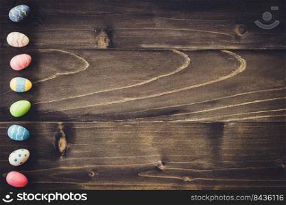 Colorful easter egg on wood background with space