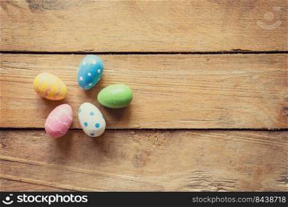 Colorful easter egg on wood background with space.