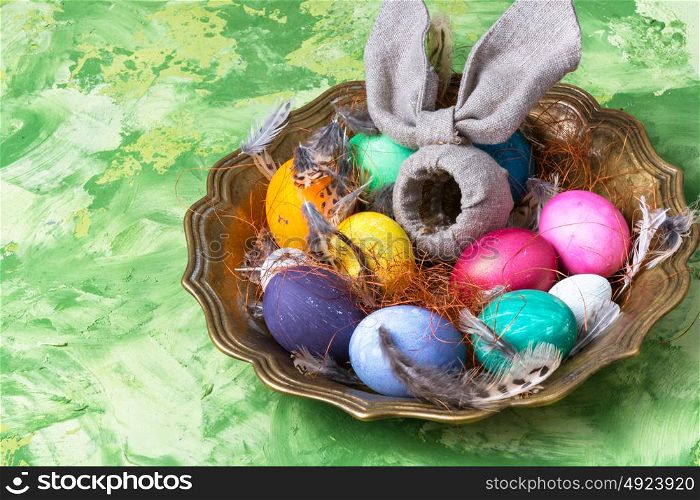 Colorful Easter eggs. Easter colored egg and a symbolic rabbit in a tray