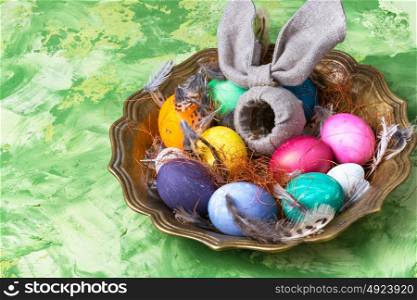 Colorful Easter eggs. Easter colored egg and a symbolic rabbit in a tray