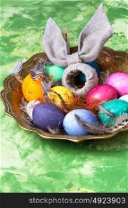 Colorful Easter eggs. Easter colored egg and a symbolic rabbit in a tray.Happy Easter