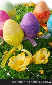colorful easter eggs in a field of grass