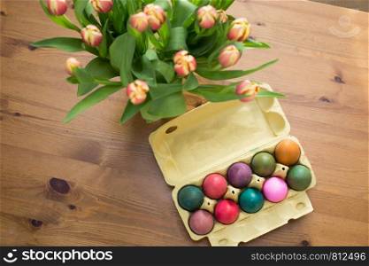 Colorful Easter eggs in box on a table, easter decoration april. Colorful Easter eggs in box on a table, easter decoration