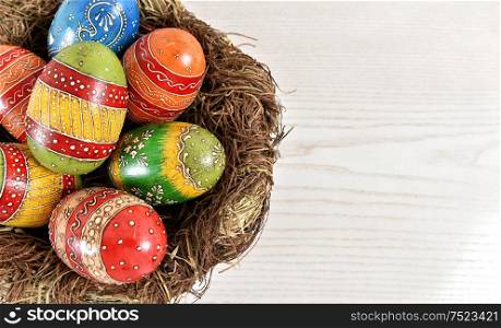 Colorful easter eggs in nest. Festive decoration
