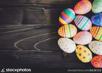 Colorful easter eggs on black wood background with copyspace. 