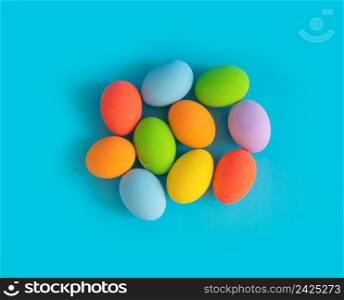 Colorful easter eggs on blue background. Food decoration on holiday.