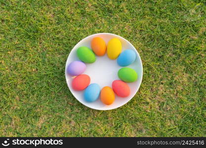 Colorful easter eggs on natural green grass background. Food decoration on holiday.