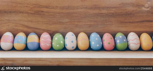 colorful easter eggs on wooden background with copy space.