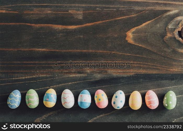 Colorful easter eggs on wooden table background vintage with copy space.