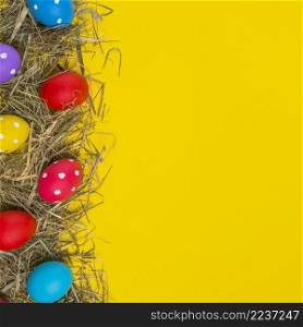 colorful easter eggs scattered hay