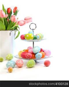 Colorful easter eggs with pink tulips on white background