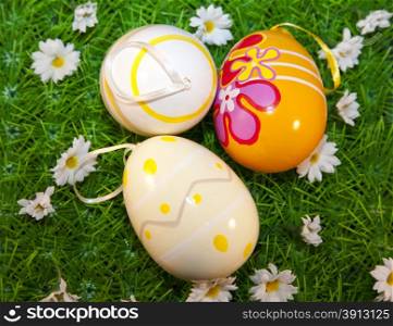 Colorful eastern eggs in grass