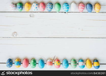 Colorful eggs easter on white wood background with space for text.